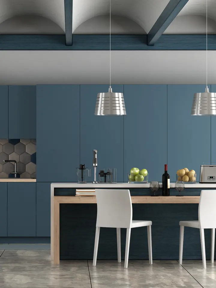 Kitchen with navy painted cabinets, a hexagon tile backsplash and pendant lights over the island