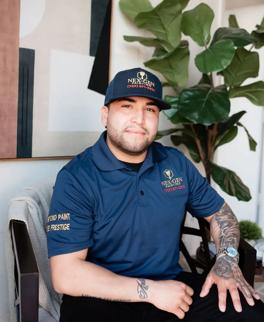 Ismael Torres, owner of Nex-Gen Painting, wearing a navy Nex-Gen polo and cap
